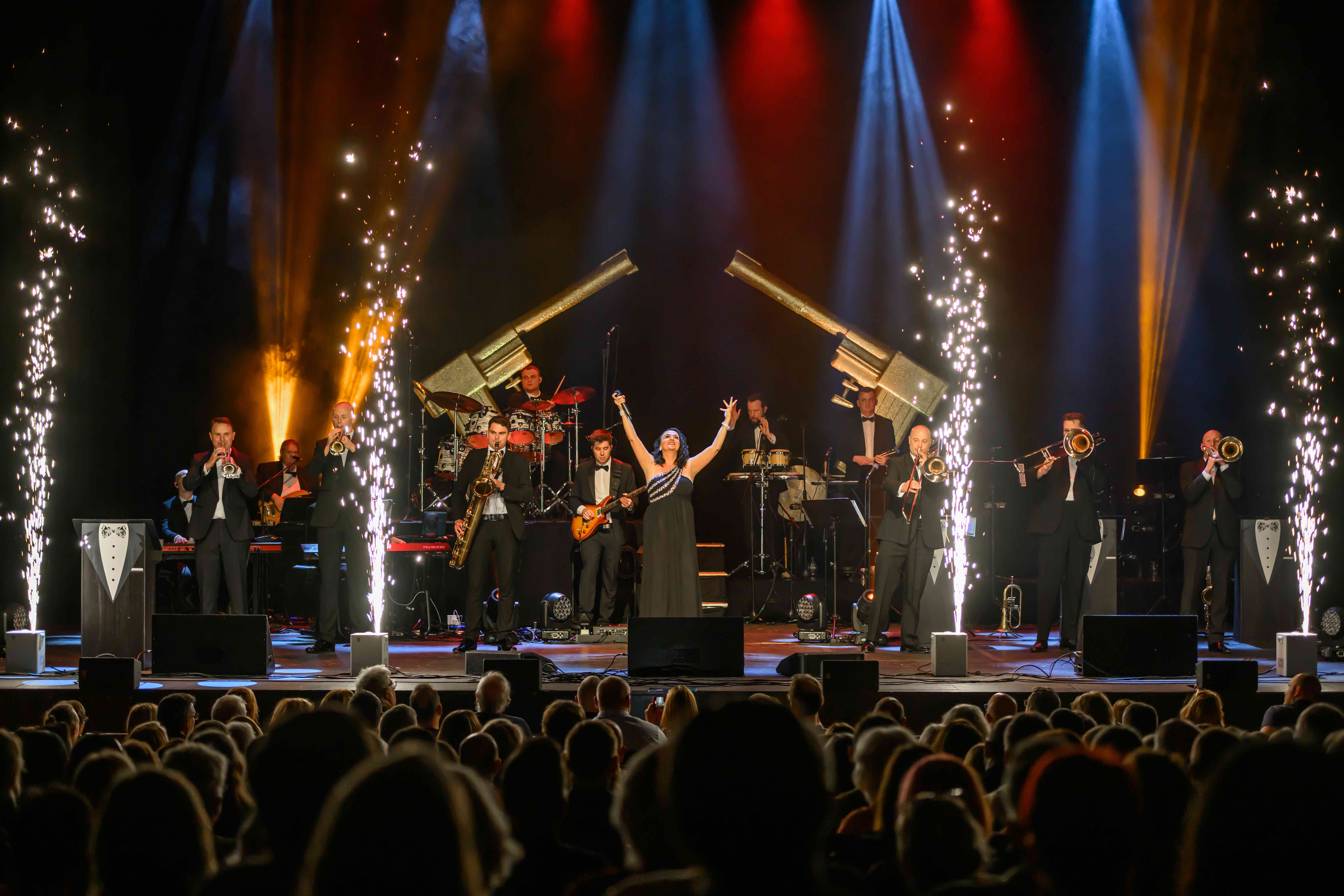 James Bond Themed Concert Spectacular featuring singers and a band on a theatre stage