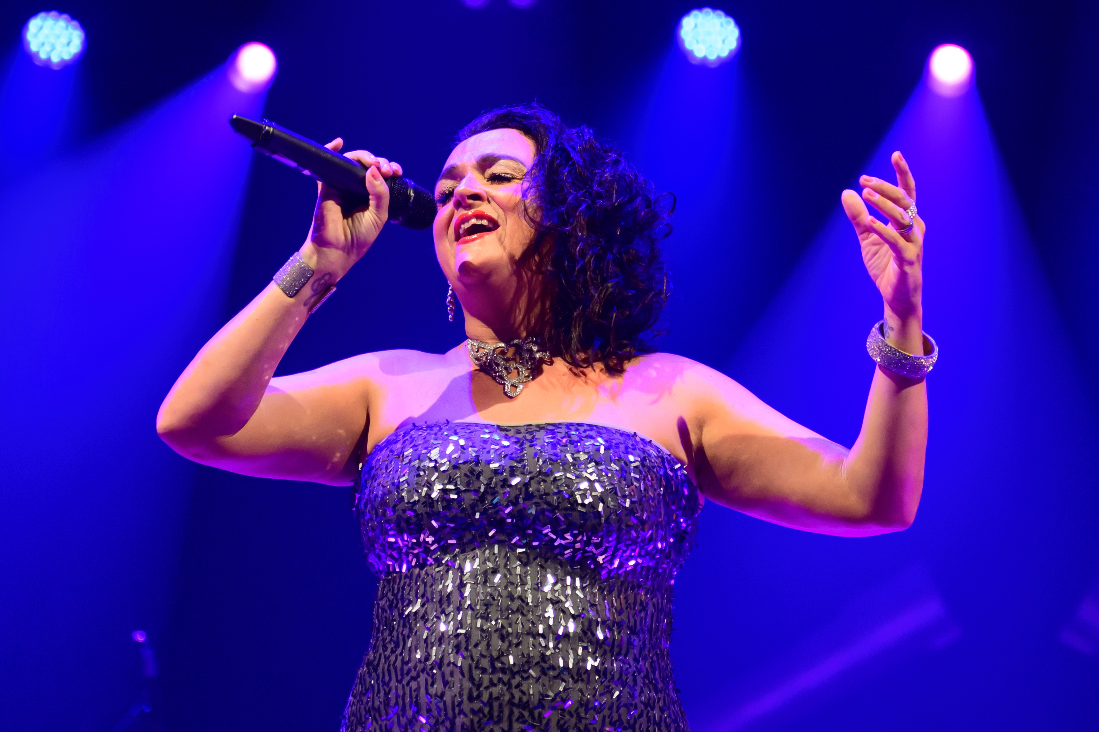 James Bond Themed Concert Spectacular featuring singers and a band on a theatre stage