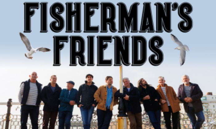 Promotional banner for the theatre show Fisherman's Friends appearing at the Victoria Theatre Halifax.  The image features a group of 8 men, singers from the band standing at the seaside.
